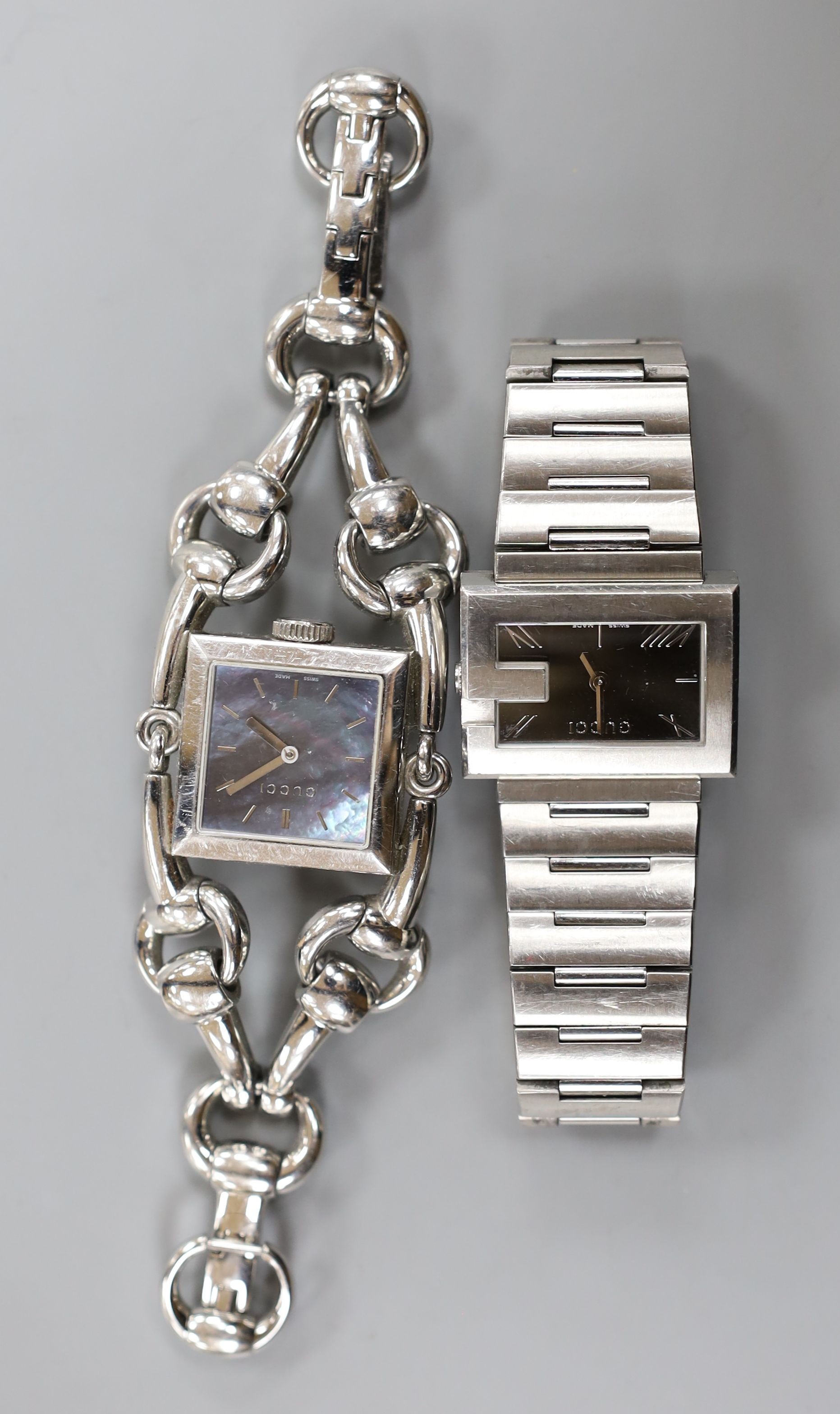 Two lady's modern steel Gucci quartz wrist watches, including one with mother of pearl dial with box.